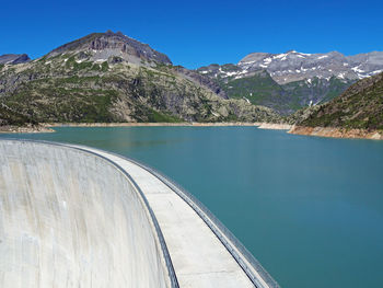 Scenic view of snowcapped mountains against clear blue sky