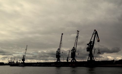 Harbor against cloudy sky