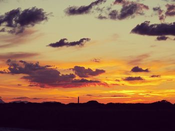 Silhouette landscape against sunset