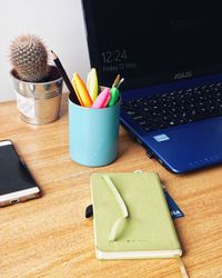 High angle view of pencils and laptop on table