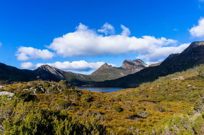 Scenic view of mountains against blue sky