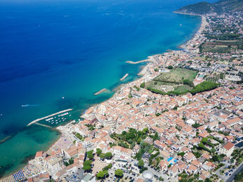 High angle view of sea and buildings in city