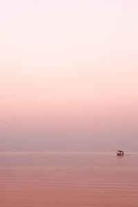 Scenic view of sea against clear sky during sunset