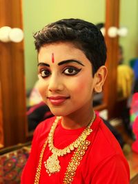 Portrait of boy wearing make-up with jewelries and costume