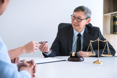 Lawyer having meeting with clients in courtroom