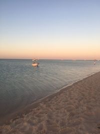 Scenic view of sea against clear sky during sunset