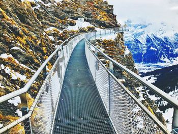 High angle view of snow covered footbridge