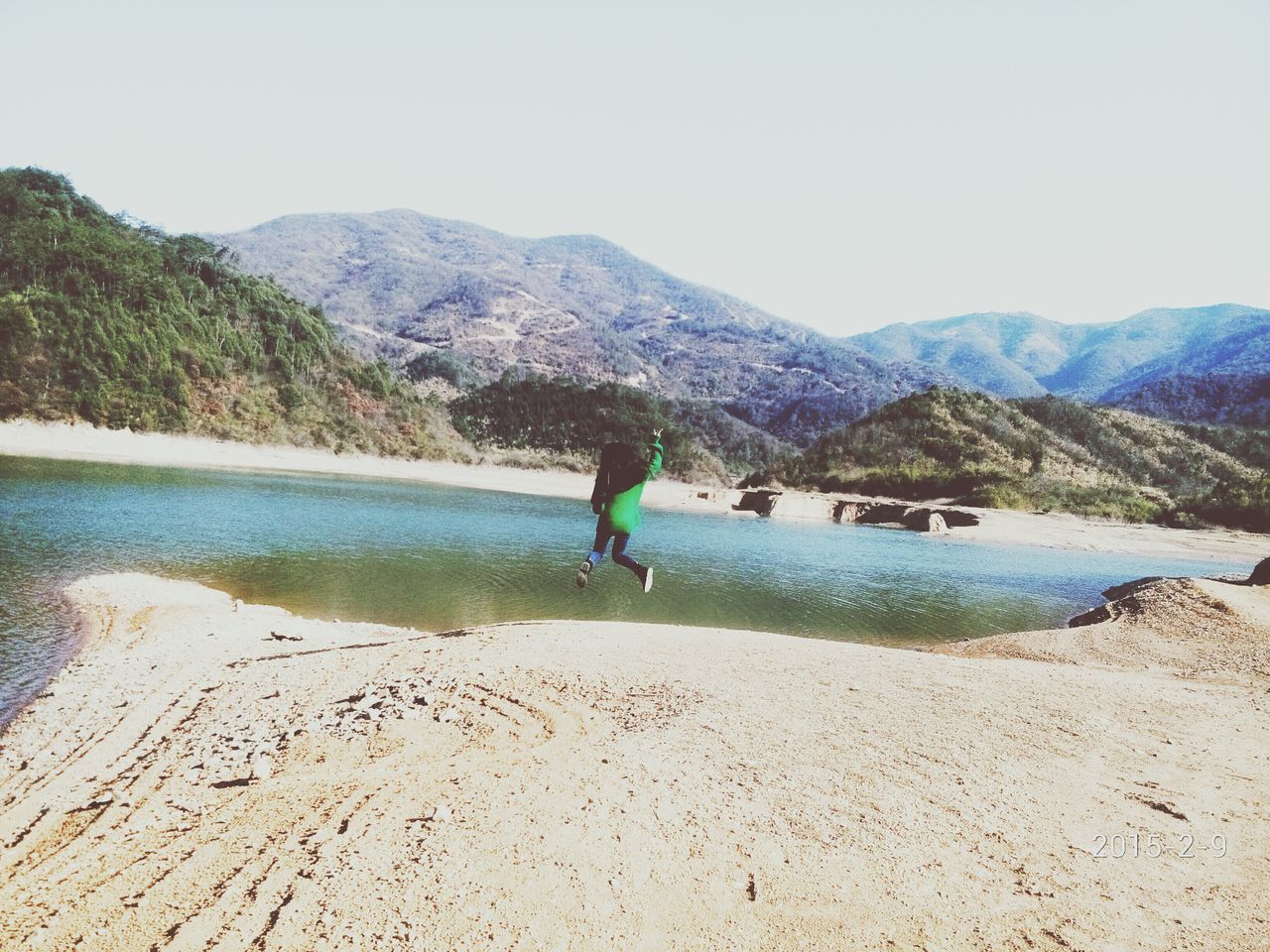 water, clear sky, mountain, leisure activity, beach, lifestyles, tranquil scene, tranquility, sand, scenics, full length, shore, beauty in nature, nature, copy space, sea, vacations, men