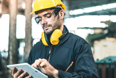 Midsection of man working with mobile phone