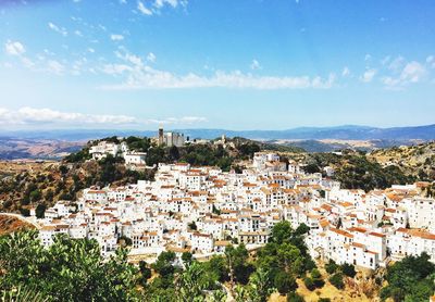 High angle view of white buildings in town against landscape