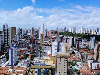 High angle view of modern buildings in city against sky