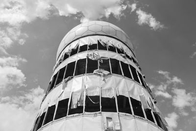 Low angle view of modern building against cloudy sky