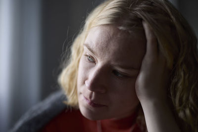 Pensive teenage girl with head in hands