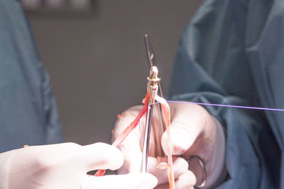 Midsection of doctor performing surgery at hospital