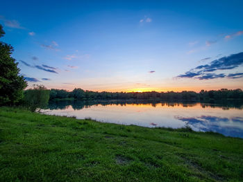 Scenic view of lake against sky during sunset