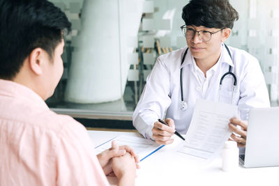 Doctor examining patient in office