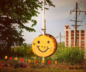 Close-up of clock on yellow wall