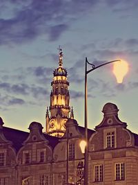 Low angle view of building against cloudy sky