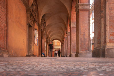 People walking in corridor of building
