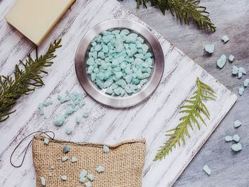 High angle view of salt and herb on wooden table