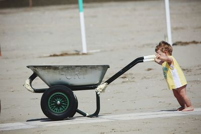 Side view of a boy holding umbrella