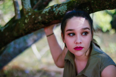 Close-up portrait of young woman in park