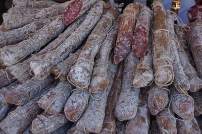 Close-up of salamis for sale in market