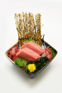 High angle view of vegetables on plate against white background