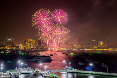 Colorful fireworks display over the night sky of the city during a festival