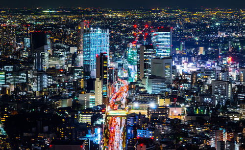 High angle view of illuminated buildings in city at night