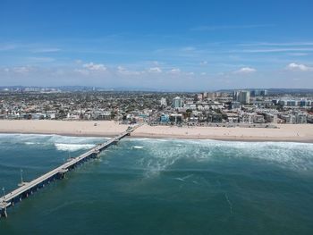 Aerial view of sea and buildings against sky