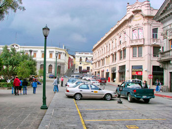 Vehicles on road amidst buildings in city