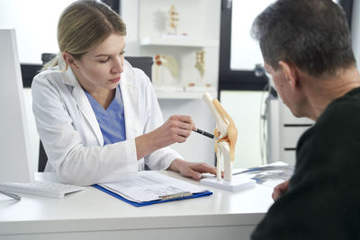 Doctor working at table