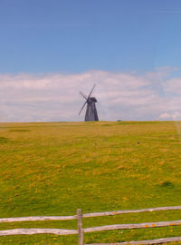 Man standing on field against sky