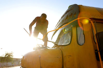 Low angle view of man standing against clear sky