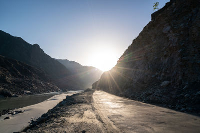 Road amidst mountains against sky