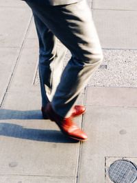 Low section of woman standing on tiled floor