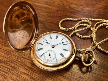 Close-up of clock on table