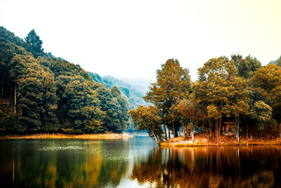 Scenic view of lake against clear sky during autumn