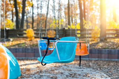 Empty chairs in park during autumn