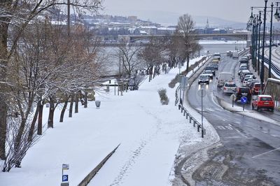 Snow covered road in city during winter