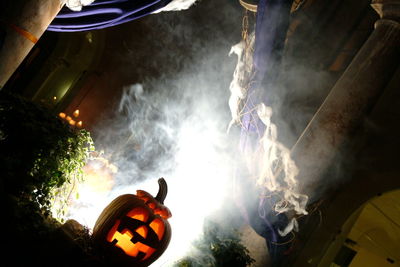 Low angle view of illuminated pumpkin against sky at night