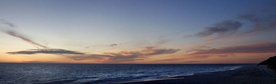 Scenic view of sea against sky at sunset