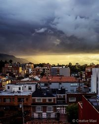 View of cityscape against cloudy sky