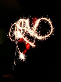Illuminated firework display at night