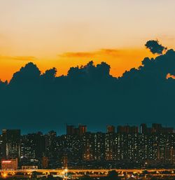 Silhouette buildings against sky during sunset