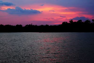 Scenic view of lake against orange sky