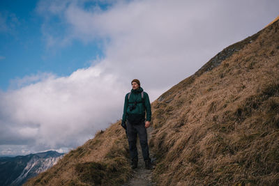 Man standing on mountain against sky