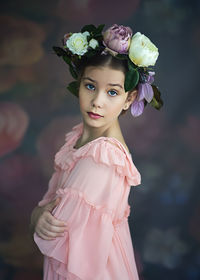 Portrait of woman with pink flower