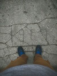 Low section of man standing on footpath